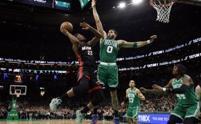 Miami Heat forward Jimmy Butler goes for a layup against Boston Celtics forward Jayson Tatum