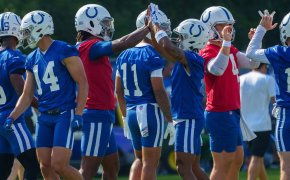 Anthony Richardson high-fives teammates at Colts training camp.