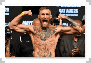 Conor McGregor flexing at a UFC weigh in