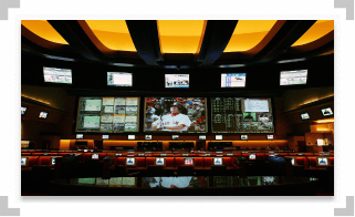 Multiple televisions displaying sports games in a retail sportsbook location